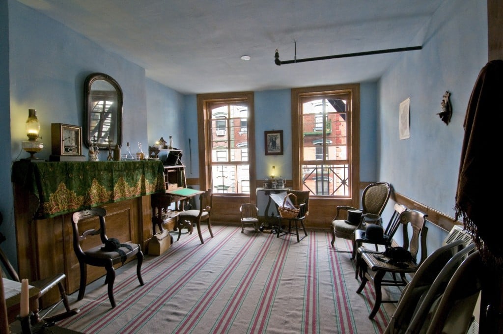 Moore family parlor with a large striped rug covering the floor and chairs arranged in a circle around the room