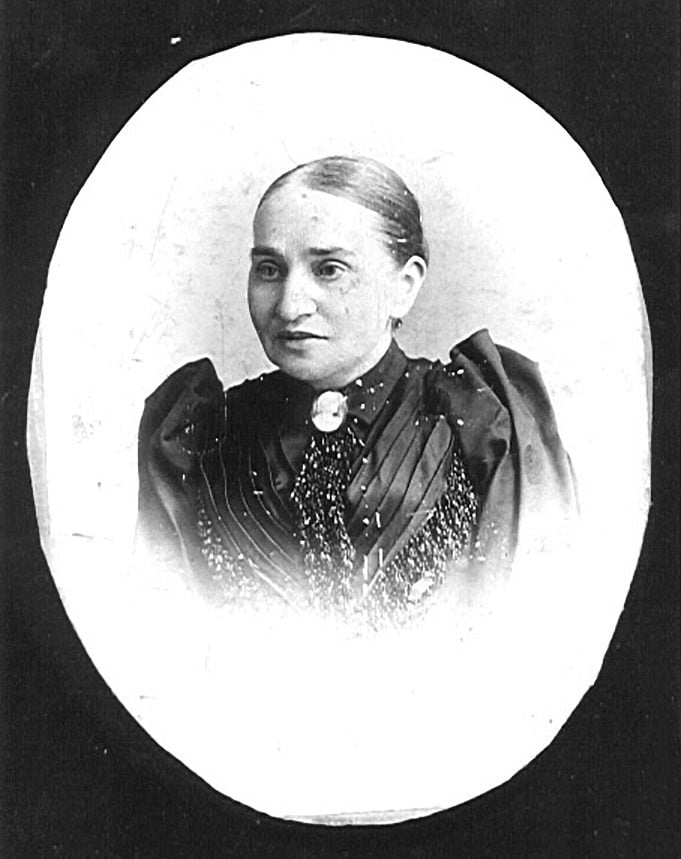 Black and white photo of 97 Orchard tenant Nathalie Gumpertz with her hair pulled back, wearing an elaborate dress with a brooch
