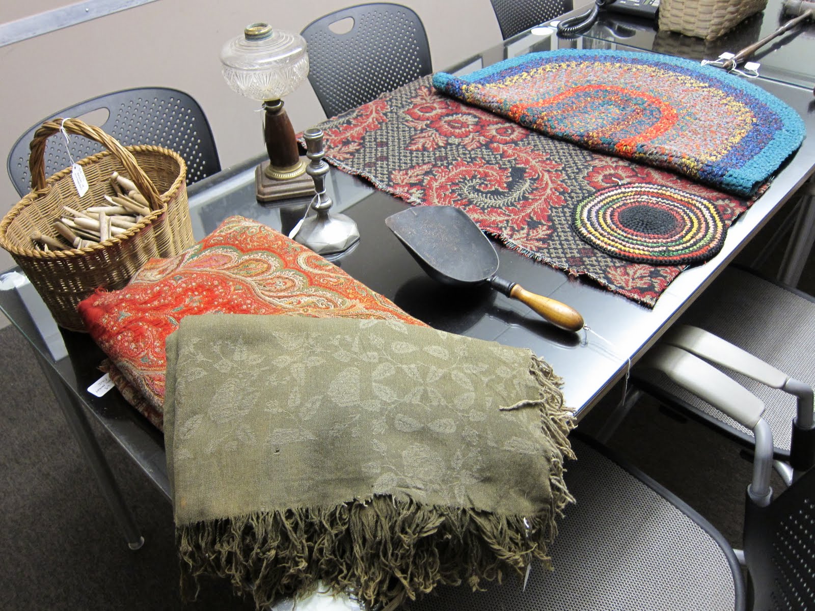 Objects found at flea market for the Shop Life tour at the Museum - which include some fabrics, a carpet, and a forged trowel scoop