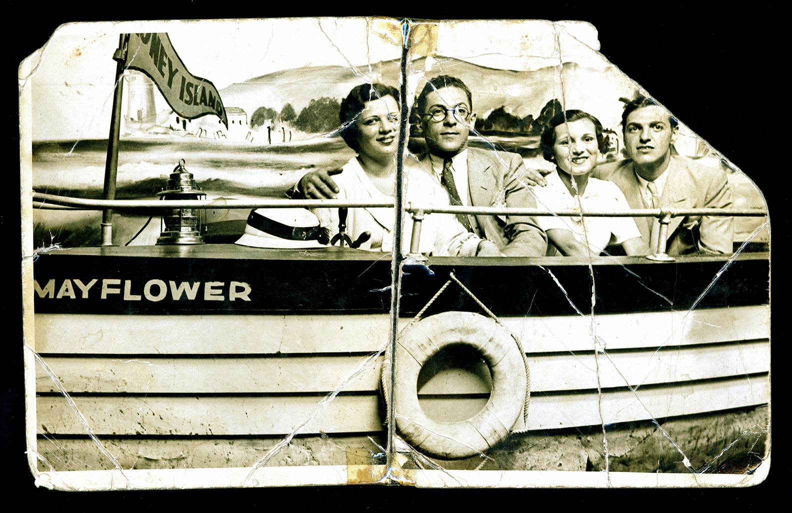 Two couples pose together in a "Mayflower" boat prop at Coney Island in the early 1900s