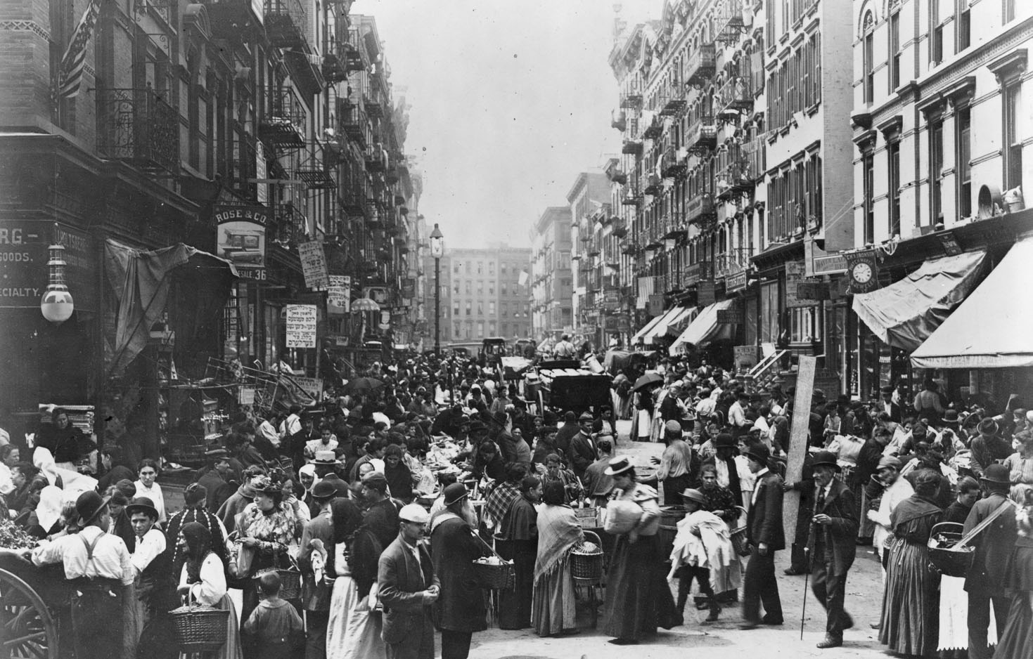 Photo of a crowd gathered at a busy time in Orchard Street shopping, walking, chatting, and working