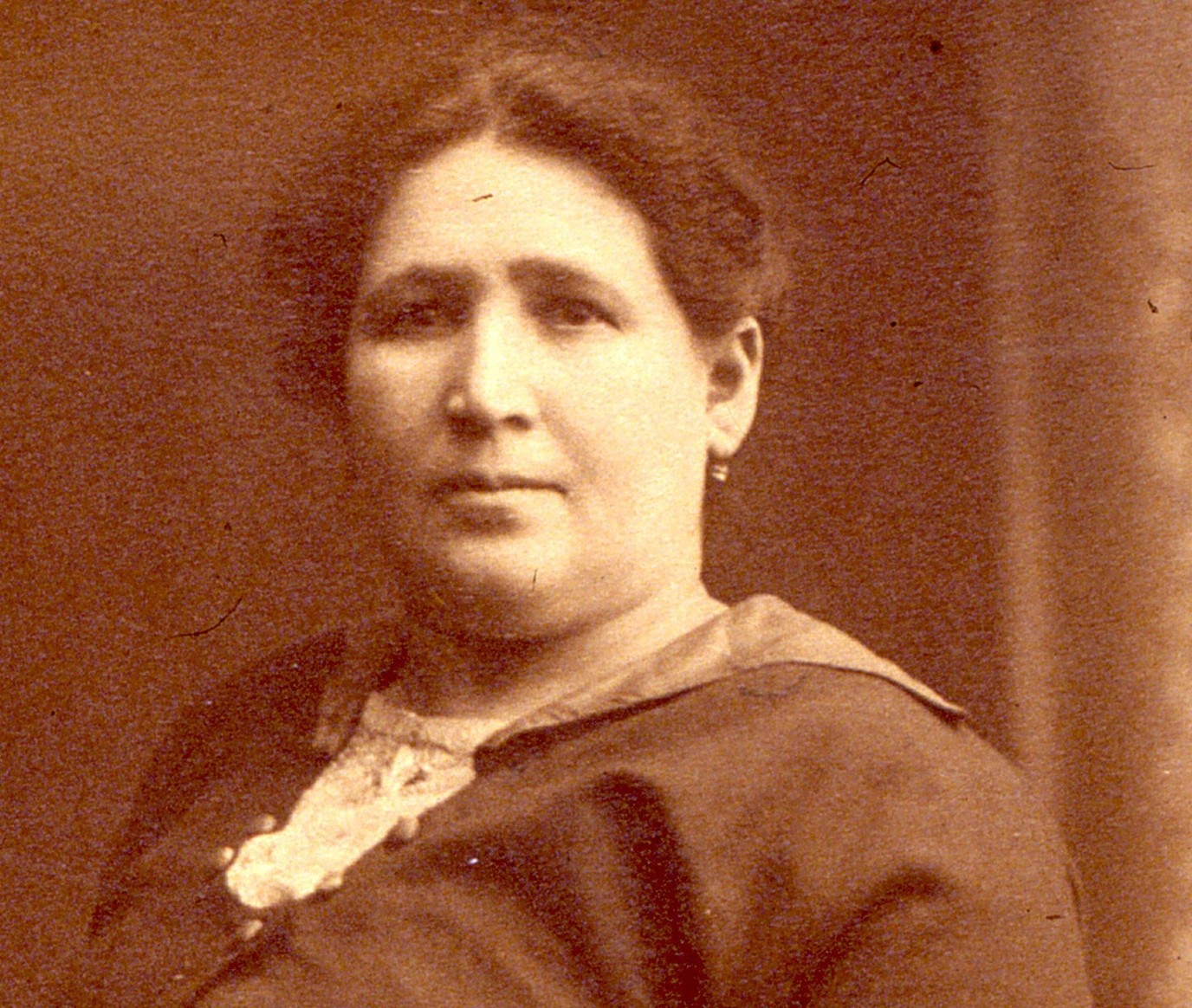 Sepia-toned headshot of Fannie Rogarshevsky with her hair pulled back and a neutral expression