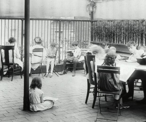 Photo of children reading on the roof deck of the Rivington Street library.