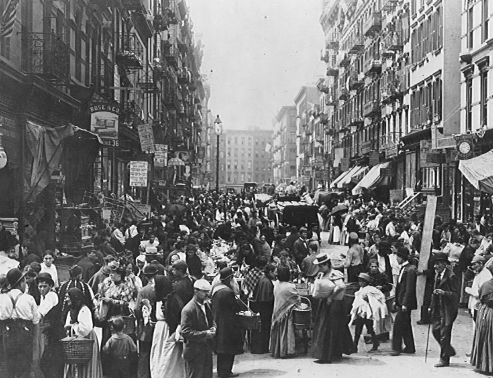 Old photo of a busy street crowded with people