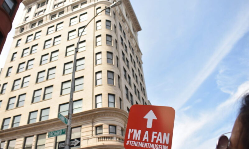 "I'm a Fan" sign held outside the Jarmulowsky bank building