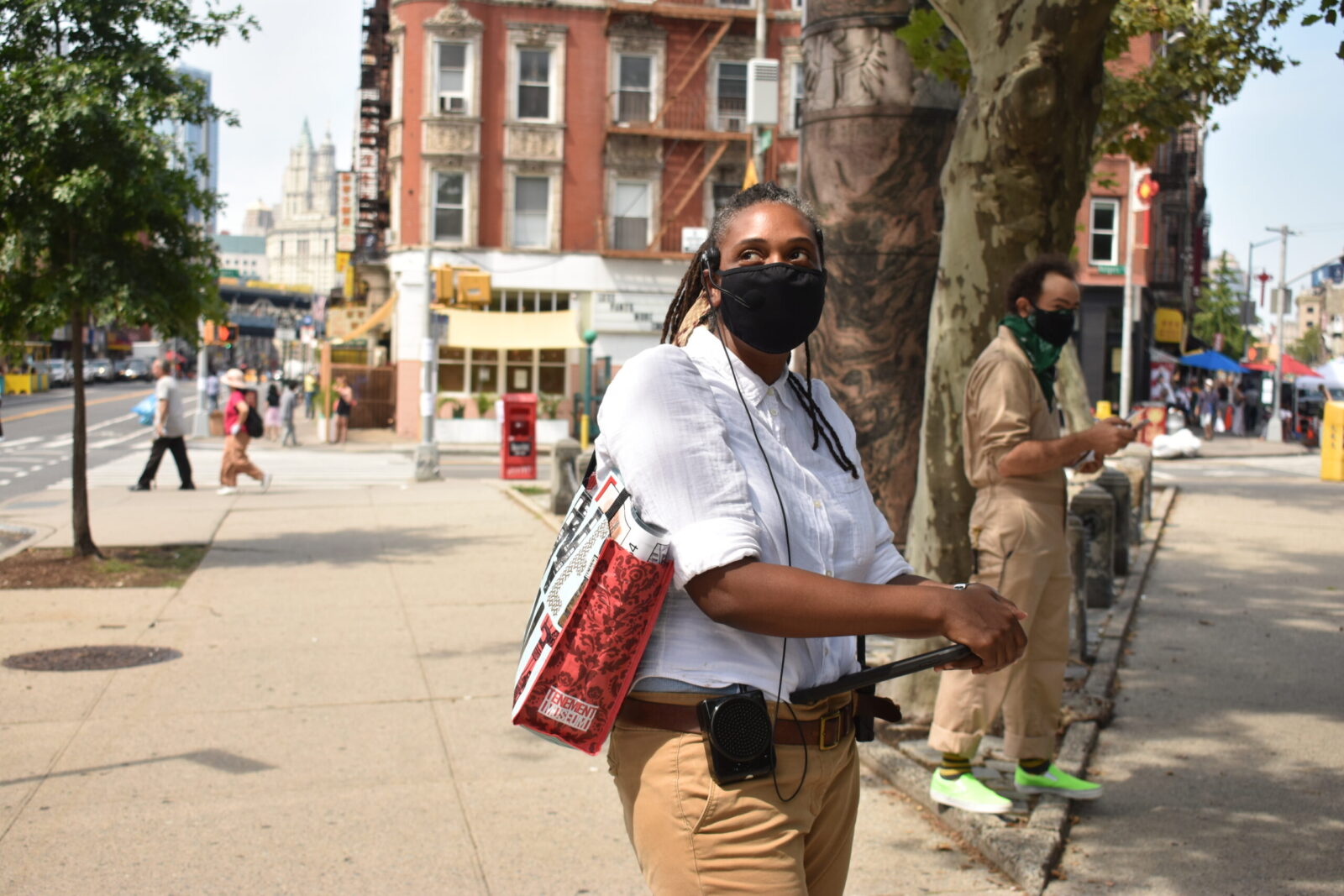 Masked tour guide leading a tour