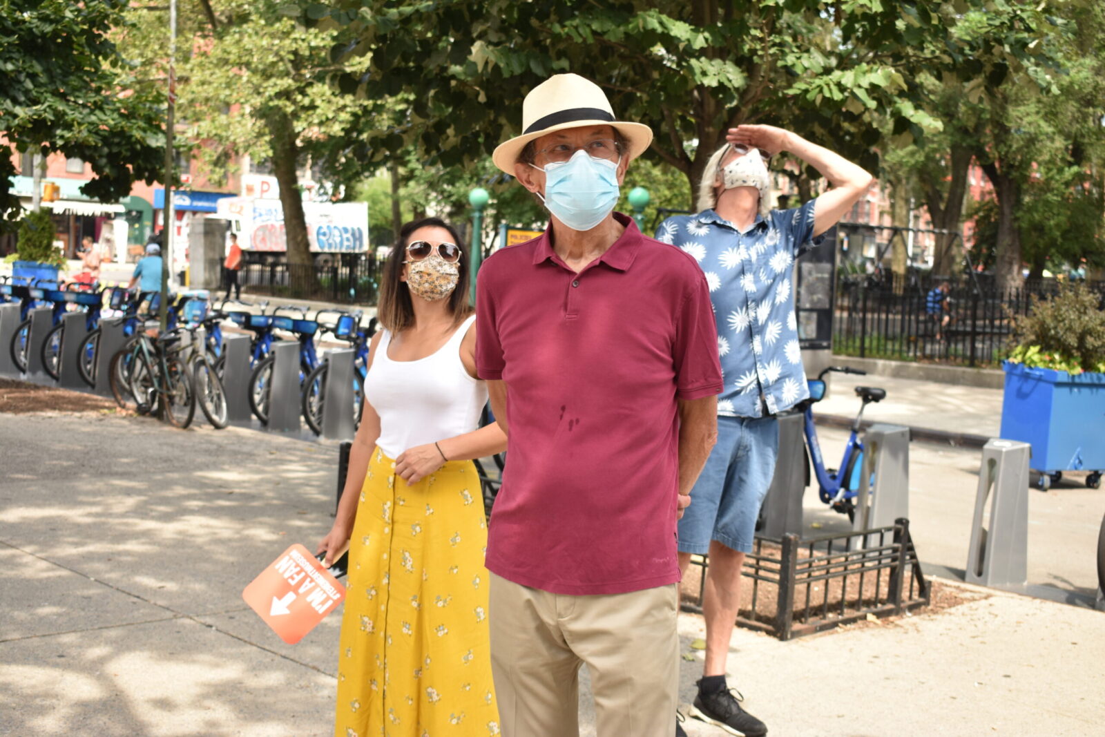 Masked individuals sightseeing on an outdoor tour