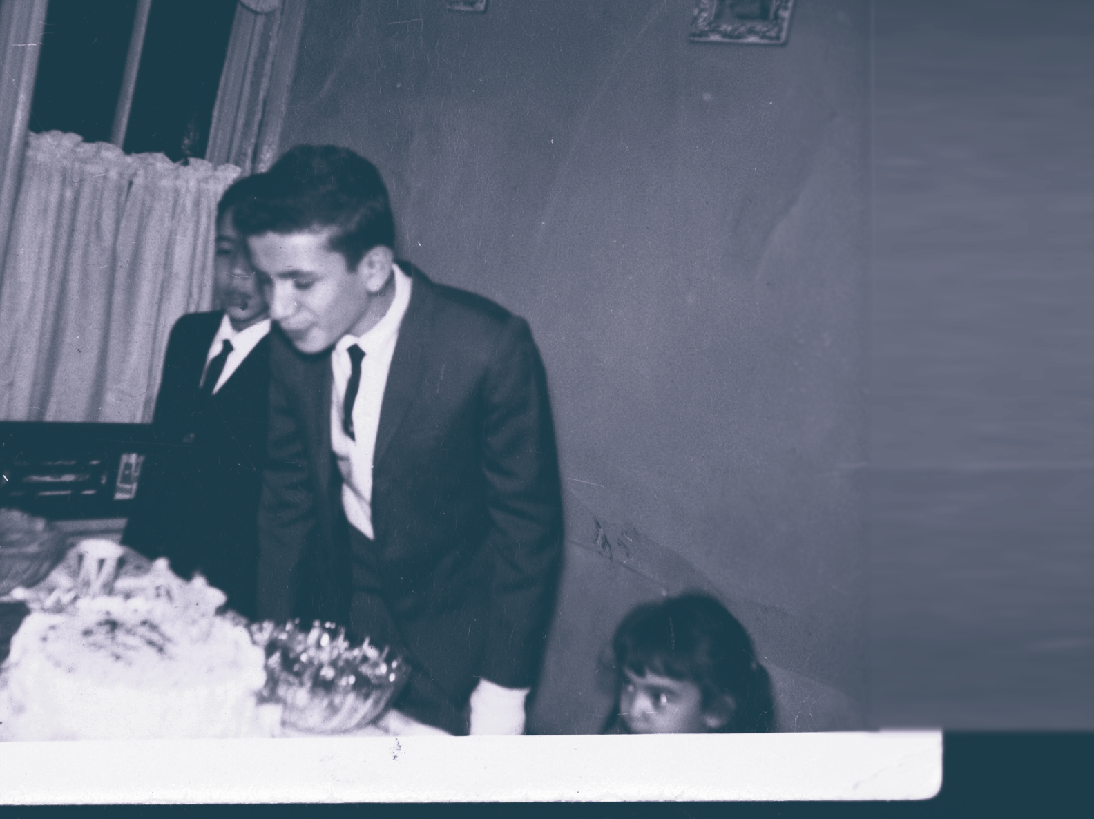 Black and White Photo of boy blowing out birthday candles