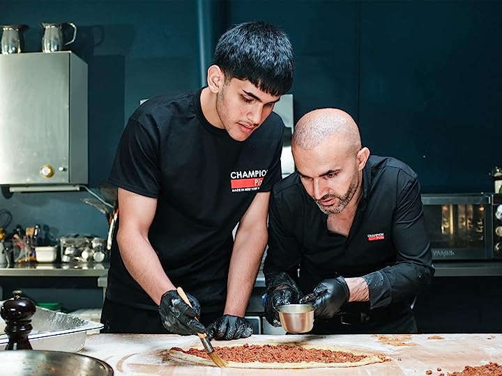 Two men making pizza