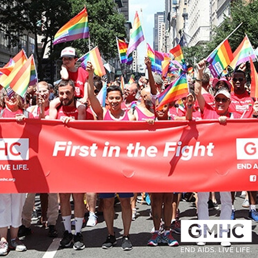 Group holding LGBTQ flags and red banner